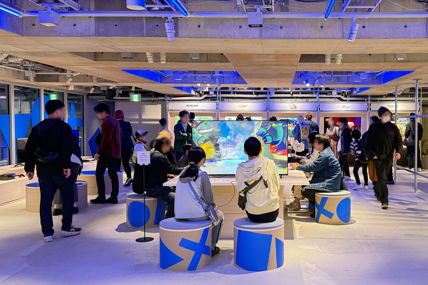 Photo of the B2 game corner, bustling with people enjoying PlayStation 5 games.