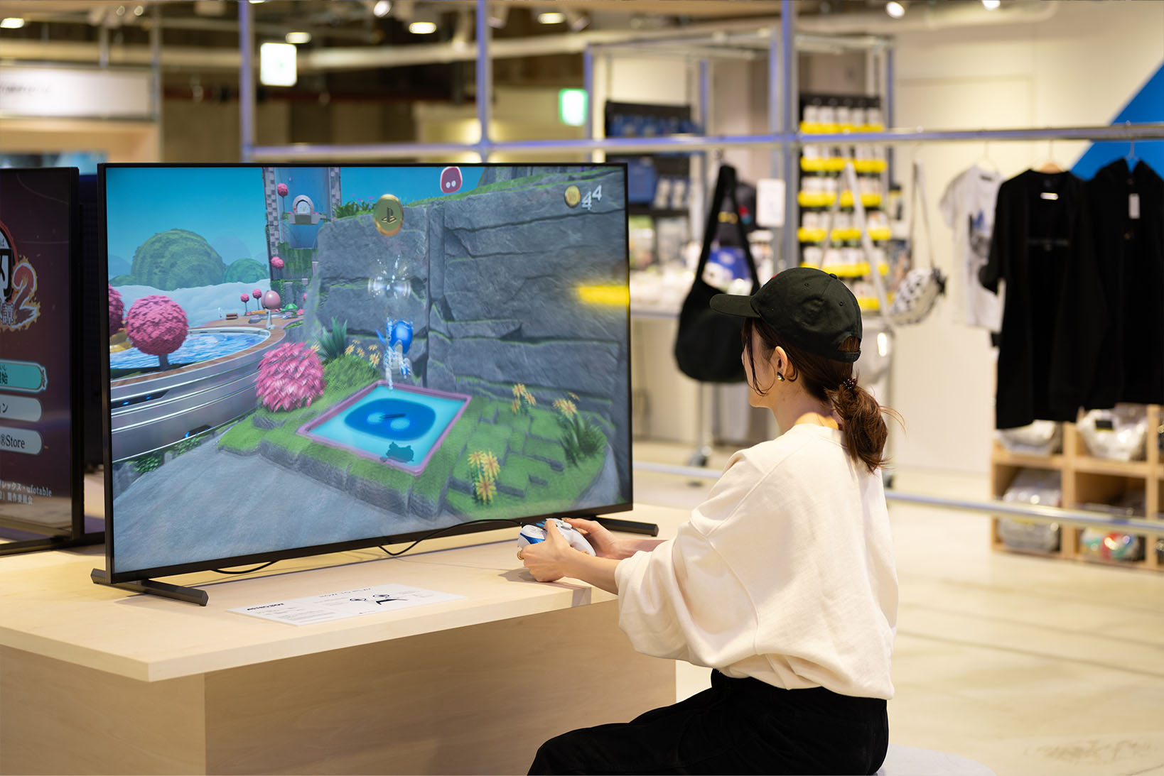 Photo of the B2 game corner, showing a player engaged in 'ASTRO BOT'.