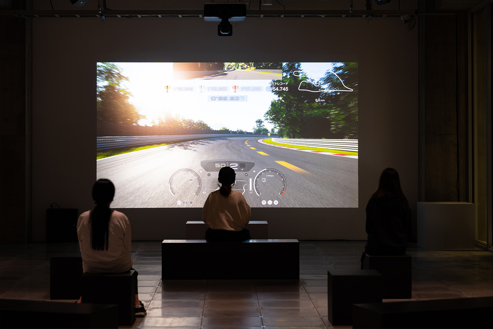 Photo of the 3F Time Attack Challenge event, featuring participants attempting the time attack in 'My First Gran Turismo'.