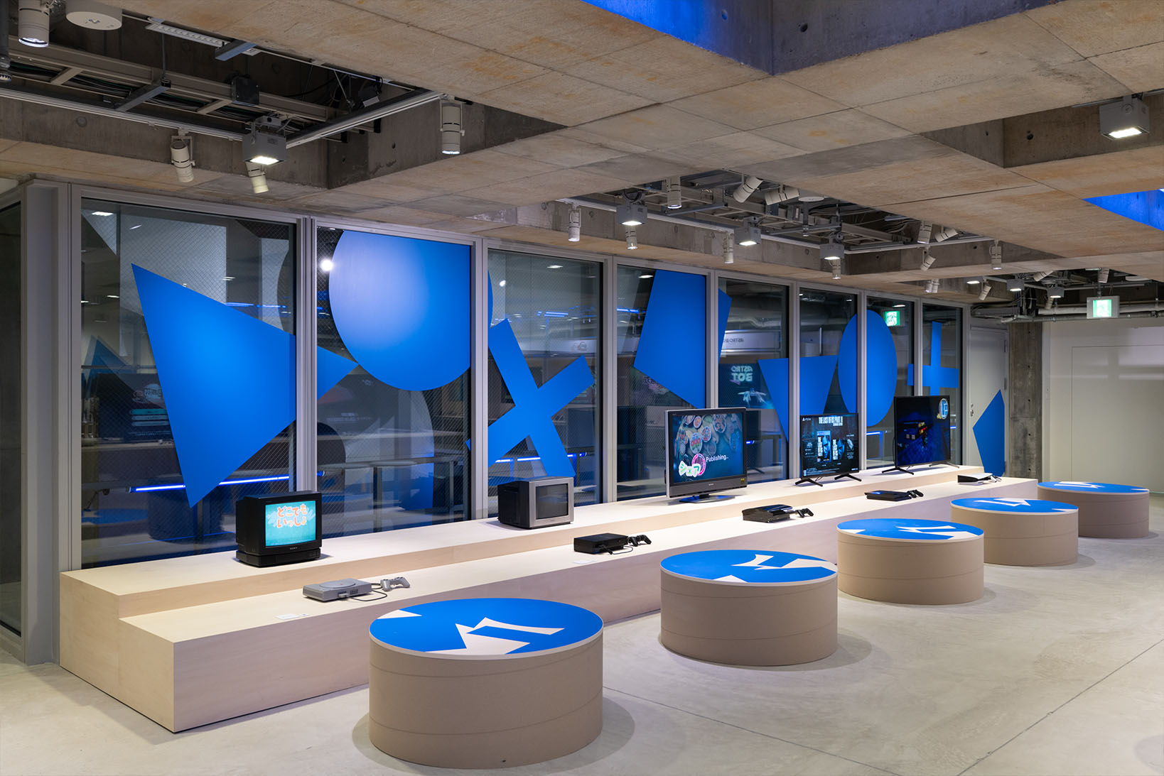 Photo of the B2 archive corner, displaying a combination of historical PlayStation hardware and televisions from that era.